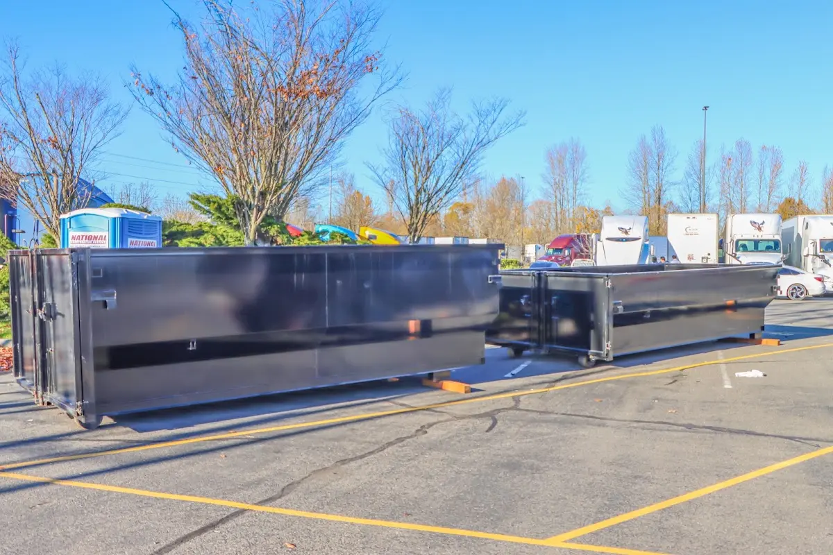 Professional dumpster rental service with roll-off container on residential driveway in Kaukauna